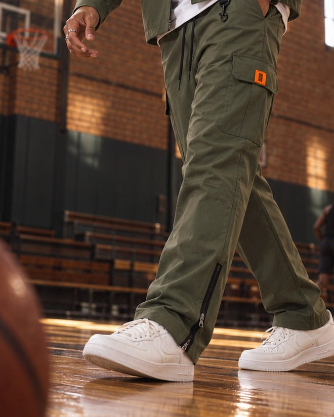 AJ Tech Cargo Pant Khaki, close-up of the thigh pocket, orange CS tab and ankle zips