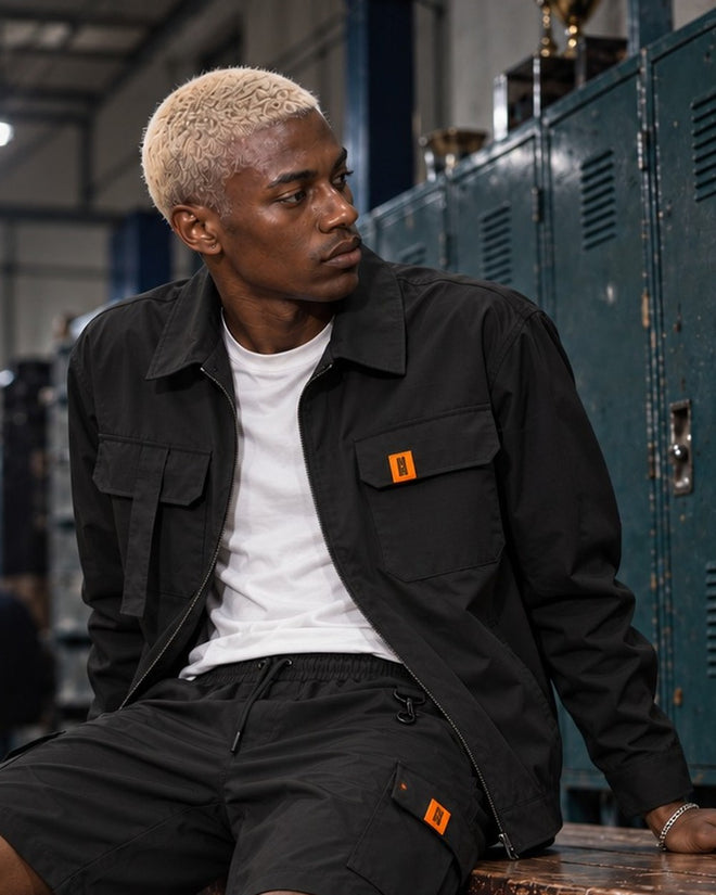AJ Tech Utility Overshirt Black, close-up of the chest pockets and orange CS tab
