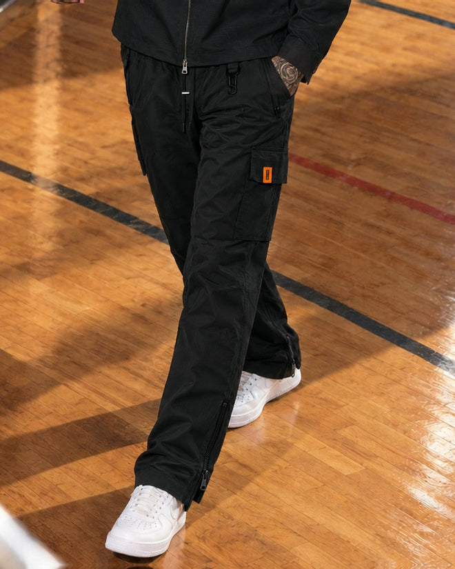 AJ Tech Cargo Pant Black, close-up of the thigh pocket, orange CS tab and ankle zips